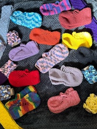 a group of colorful crocheted slippers on a table